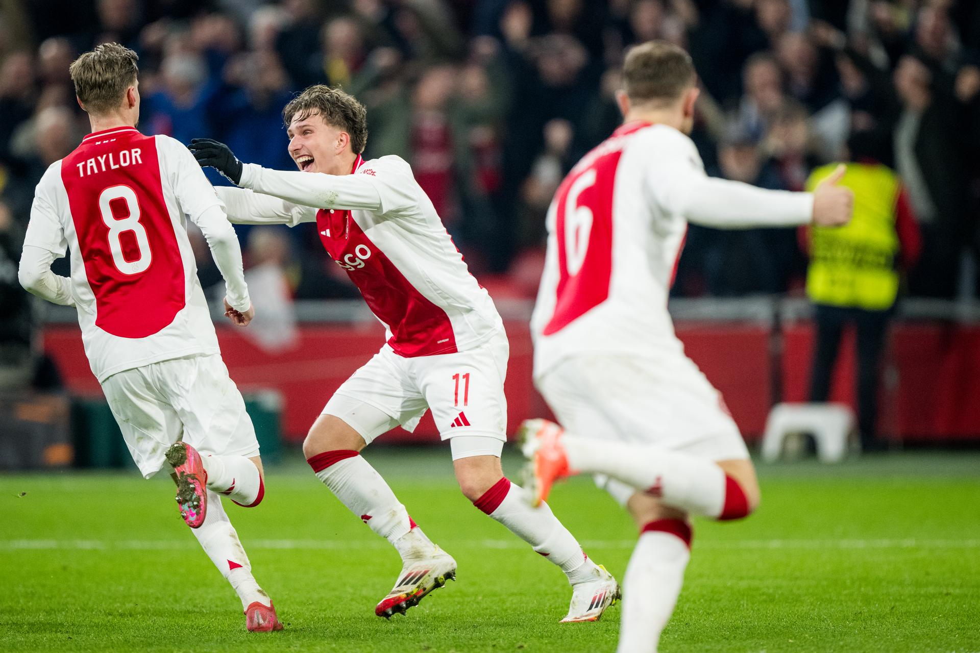 Ajax' Kenneth Taylor and Ajax' Mika Godts celebrate during a soccer match between Dutch AFC Ajax and Belgian Royale Union Saint-Gilloise, Thursday 20 February 2025 in Amsterdam, the Netherlands, the return leg of the Knockout phase play-offs of the UEFA Europa League competition. BELGA PHOTO JASPER JACOBS
