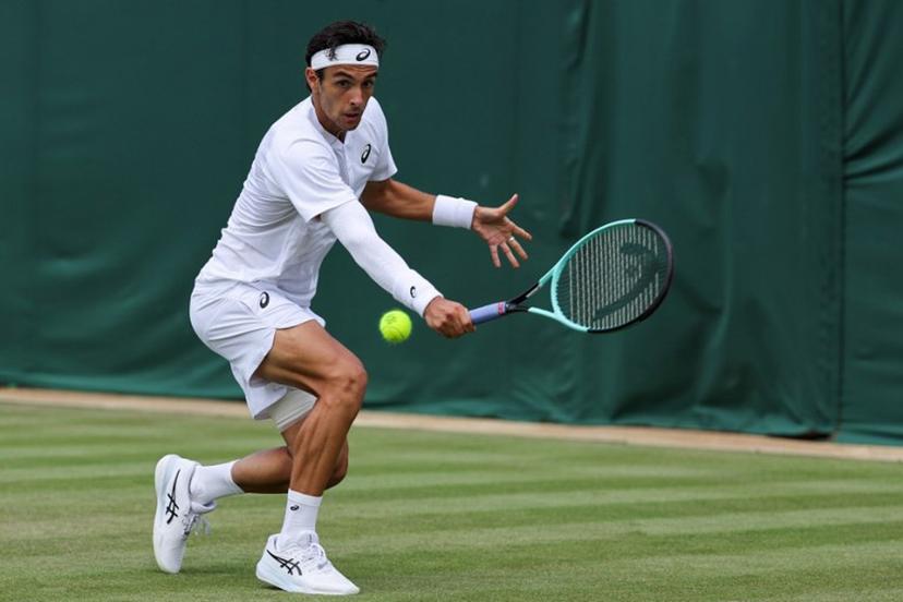 Italy's Lorenzo Musetti plays a backhand return to Georgia's Nikoloz Basilashvili during their men's singles first round tennis match on the second day of the 2025 Wimbledon Championships at The All England Lawn Tennis and Croquet Club in Wimbledon, southwest London, on July 1, 2025.  Adrian Dennis / AFP