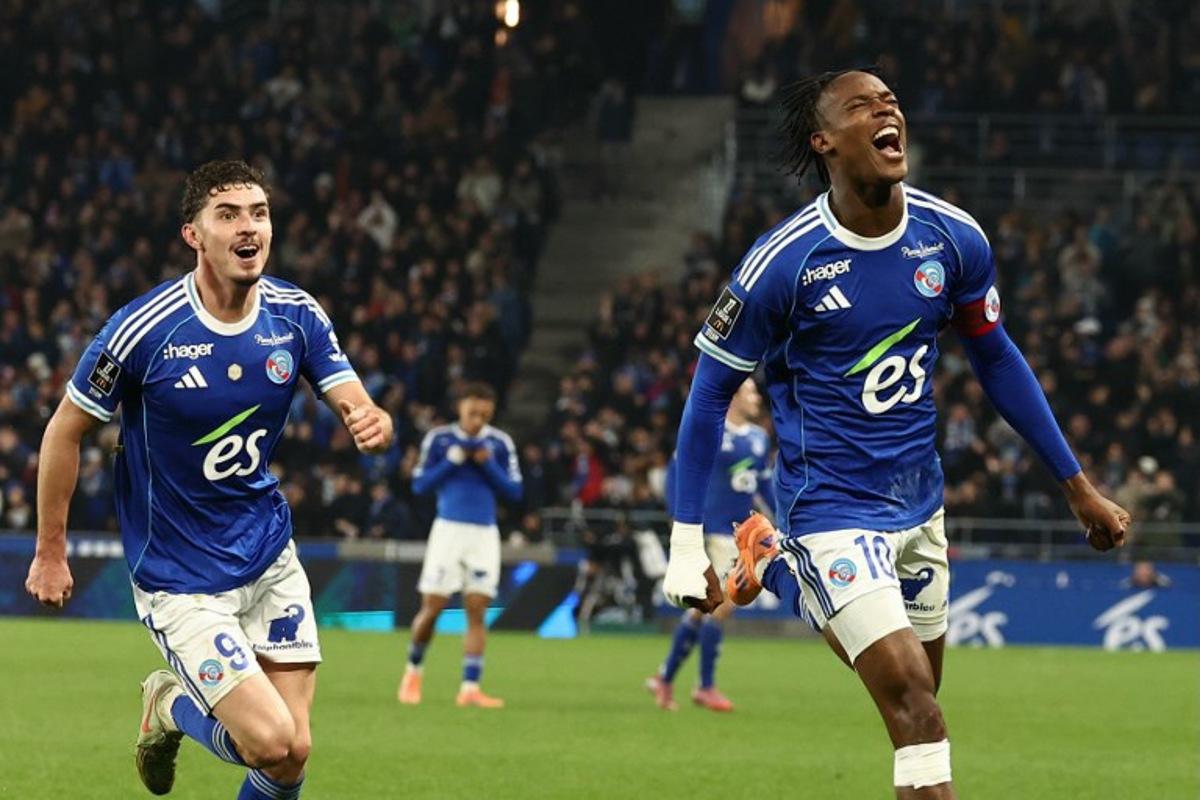 Strasbourg's Dutch forward #10 Emanuel Emegha (R) celebrates with Strasbourg's Argentine forward #09 Joaquin Panichelli after scoring his team's second goal during the French L1 football match between RC Strasbourg Alsace and Lille LOSC at the Stade de la Meinau in Strasbourg, eastern France, on November 9, 2025.  Frederick FLORIN / AFP