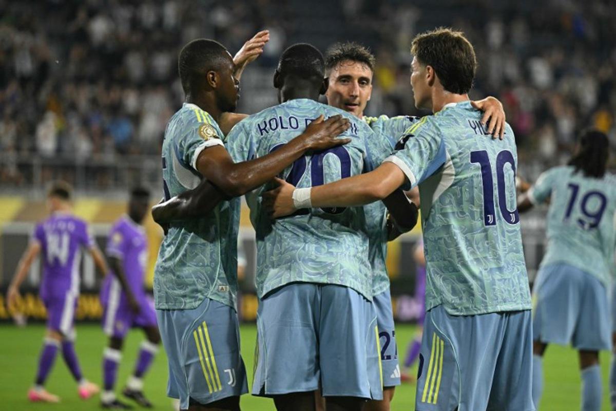 Juventus' French forward #20 Randal Kolo Muani (C) celebrates with teammates after scoring his team's first goal during the FIFA Club World Cup 2025 Group G football match between Italy's Juventus and UAE's Al Ain FC at the Audi Field stadium Washington, DC, on June 18, 2025.  ROBERTO SCHMIDT / AFP