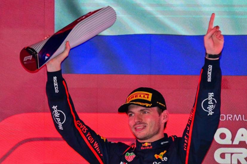 Red Bull Racing's Dutch driver Max Verstappen holds up the trophy on the podium after winning the Formula One Qatar Grand Prix at the Lusail International Circuit in Lusail on November 30, 2025.  Andrej ISAKOVIC / AFP