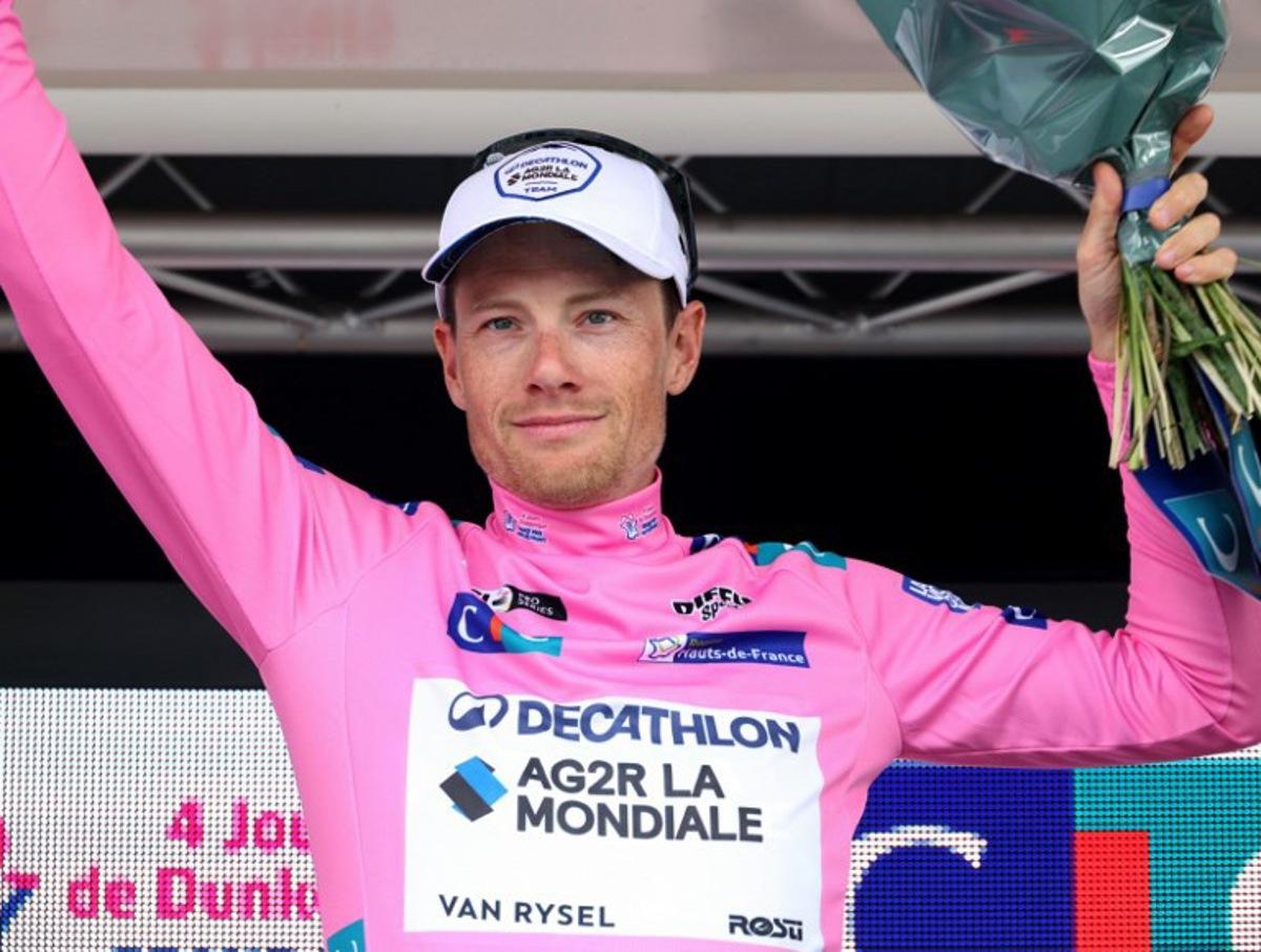 Decathlon AG2R La Mondiale's Irish rider Sam Bennett, wearing the overall leaders pink jersey, celebrates on the podium after the fourth stage of the "4 jours de Dunkerque" (Four days of Dunkirk) cycling race, 171,3 km from Mazingarbe to Pont-a-Marcq, in north France, on May 17, 2024.  FRANCOIS LO PRESTI / AFP
