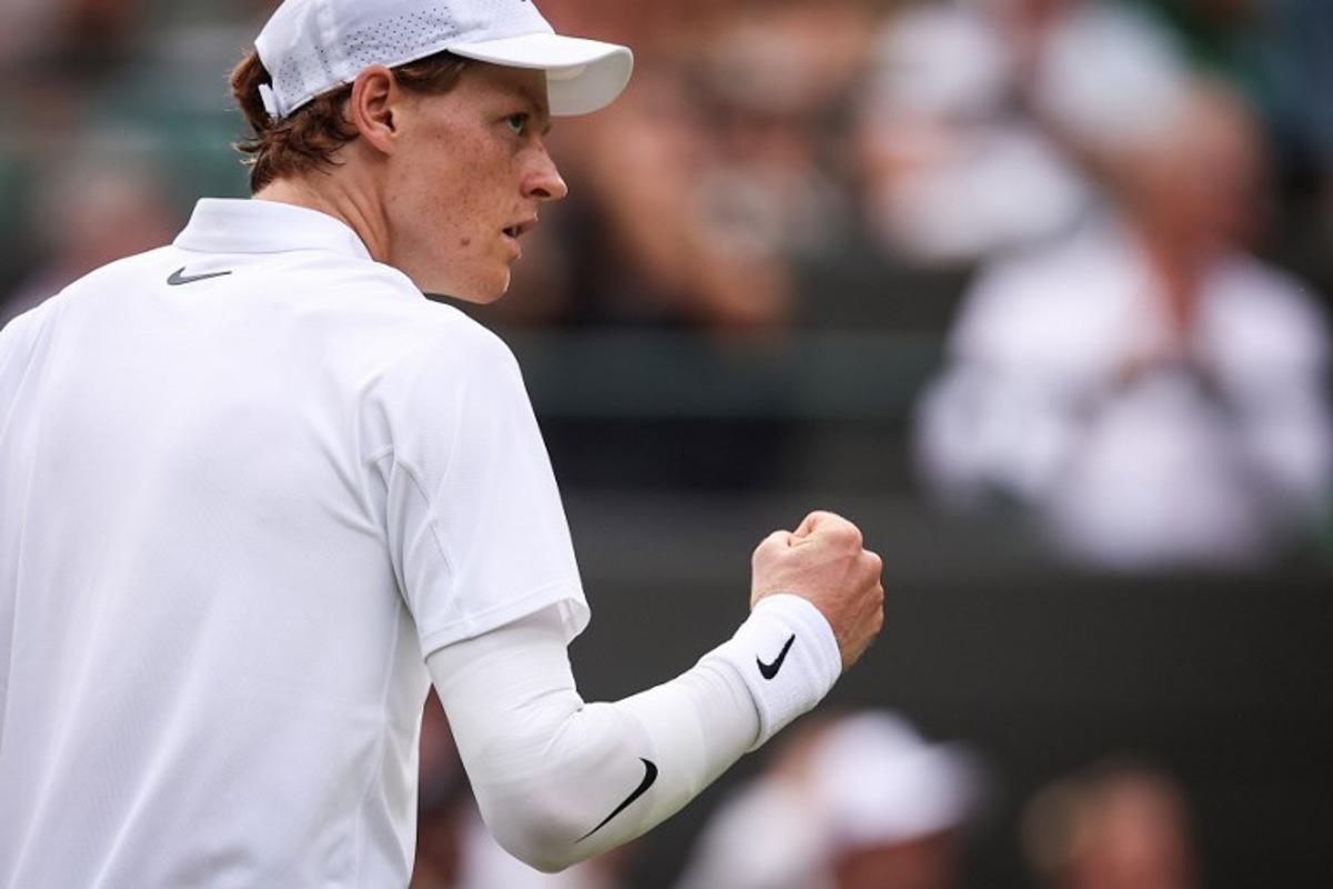 Italy's Jannik Sinner celebrates winning the second set against US player Ben Shelton during their men's singles quarter-final tennis match on the tenth day of the 2025 Wimbledon Championships at The All England Lawn Tennis and Croquet Club in Wimbledon, southwest London, on July 9, 2025.  HENRY NICHOLLS / AFP