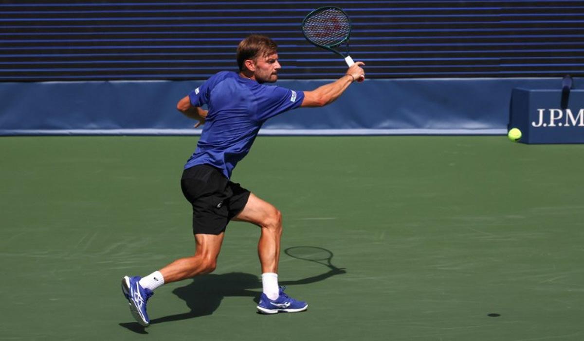 Belgium's David Goffin plays a backhand return to Italy's Lorenzo Musetti during their men's singles second round tennis match on day five of the US Open tennis tournament at the USTA Billie Jean King National Tennis Center in New York City, on August 28, 2025.  TIMOTHY A. CLARY / AFP