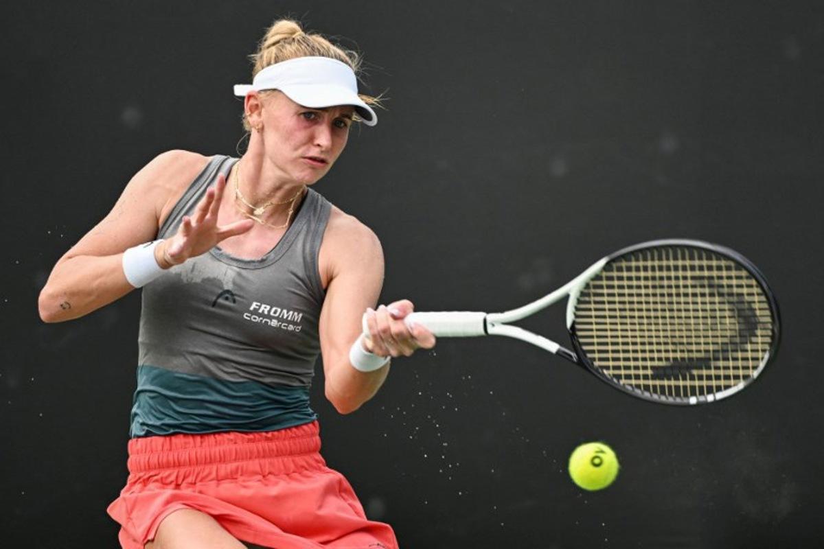 Jil Teichmann of Switzerland hits a return against  Ma Yexin of China during their women's singles qualifying match prior to the start of the WTA Guangzhou Open tennis tournament in Guangzhou, southern China's Guangdong province, on September 16, 2023.  Hector RETAMAL / AFP