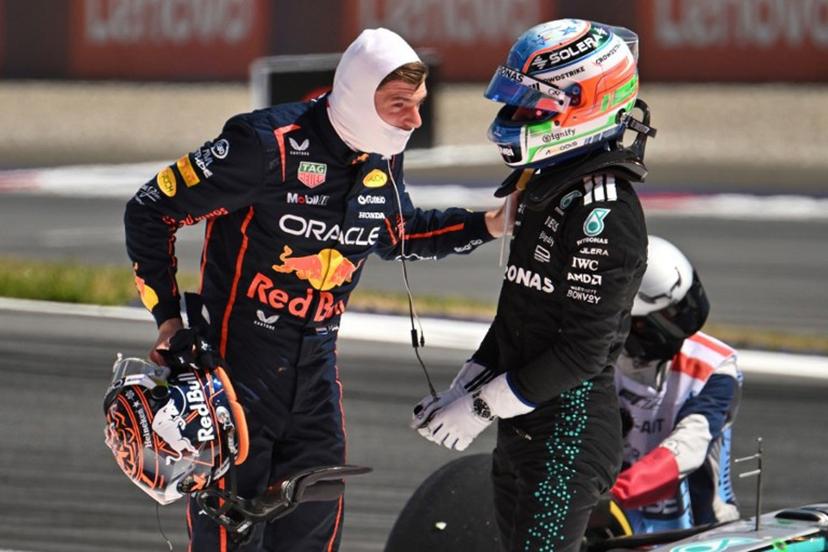 Red Bull's Dutch driver Max Verstappen (L) and Mercedes' Italian driver Kimi Antonelli speak after their cars crashed during the Formula One Austrian Grand Prix at the Red Bull Ring race track in Spielberg, Austria, on June 29, 2025.   Jure Makovec / AFP