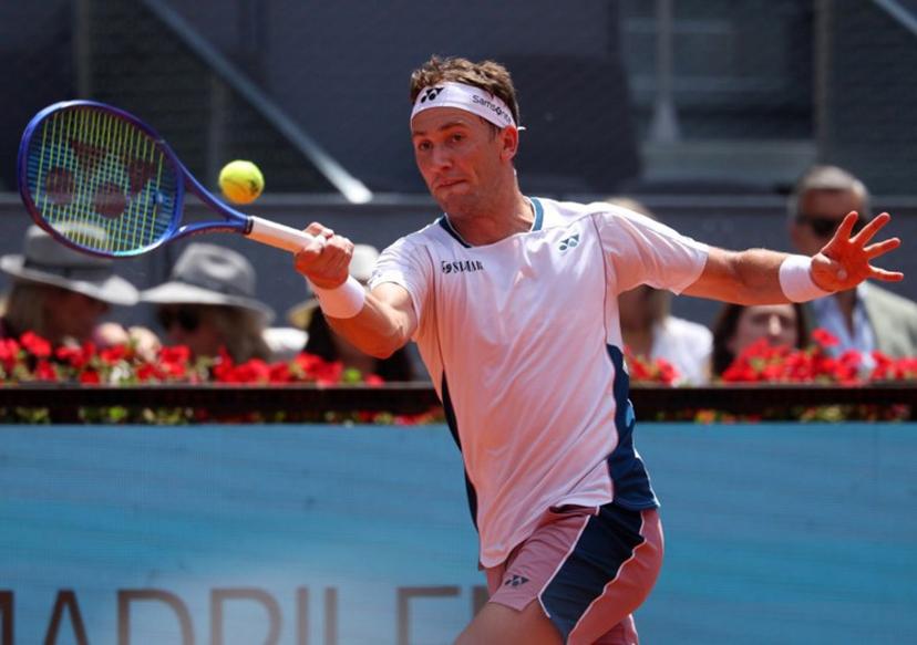 Norway's Casper Ruud returns a forehand to Russia's Daniil Medvedev  during their 2025 ATP Tour Madrid Open tennis tournament round of 16 singles match at the Caja Magica in Madrid, on May 1, 2025.  Pierre-Philippe MARCOU / AFP