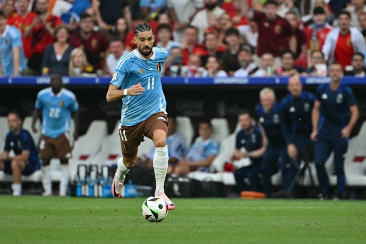 Belgium's forward #11 Yannick Carrasco runs with the ball during the UEFA Euro 2024 Group E football match between Ukraine and Belgium at the Stuttgart Arena in Stuttgart on June 26, 2024.  MIGUEL MEDINA / AFP