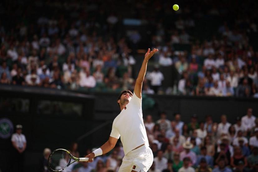 Spain's Carlos Alcaraz serves to Germany's Jan-Lennard Struff during their men's singles third round tennis match on the fifth day of the 2025 Wimbledon Championships at The All England Lawn Tennis and Croquet Club in Wimbledon, southwest London, on July 4, 2025.  HENRY NICHOLLS / AFP