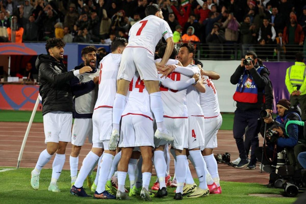 Iran's players celebrate after scoring during the FIFA World Cup 2026 Asia zone qualifiers group A football match between Iran and Uzbekistan, on March 25, 2025 in Tehran.  AFP
