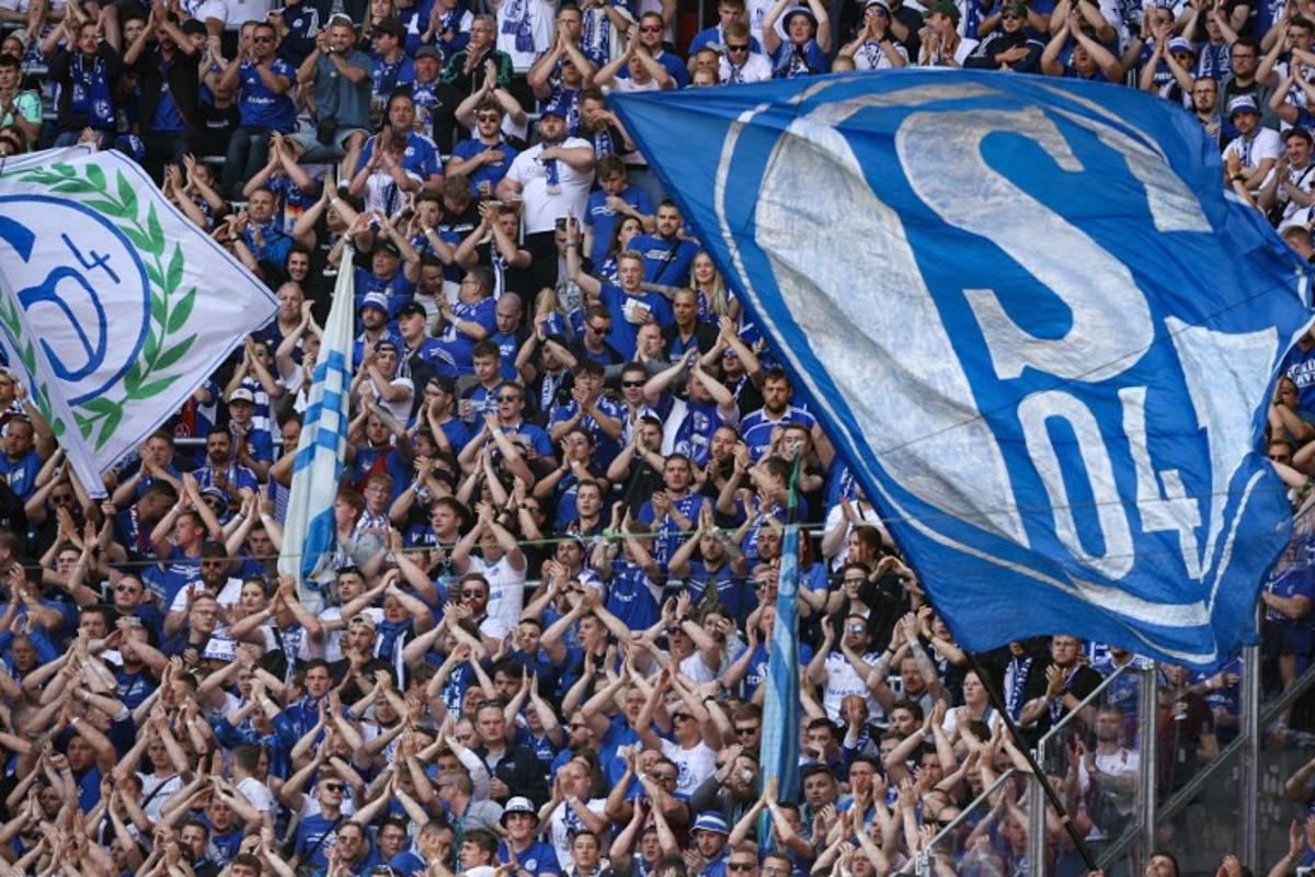 Schalke 04 football fans cheer on their team during the German first division Bundesliga football match between RB Leipzig and FC Schalke 04 in Leipzig, eastern Germany on May 27, 2023.  Ronny HARTMANN / AFP
