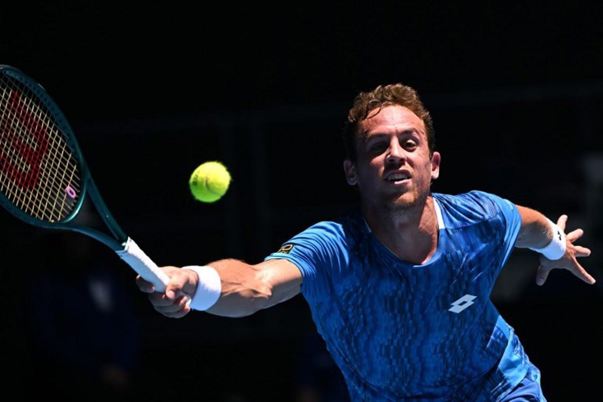 Spain's Roberto Carballes Baena hits a return against USA's Tommy Paul during their men's singles match on day six of the Australian Open tennis tournament in Melbourne on January 17, 2025.  WILLIAM WEST / AFP