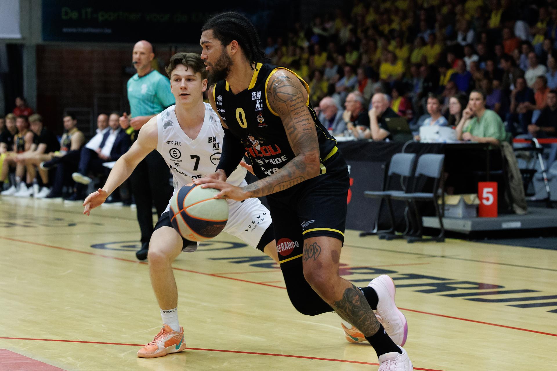 Kortrijk's Jules Isebaert and Oostende's Timmy Allen fight for the ball during a basketball match between Spurs Kortrijk and BC Oostende, Tuesday 20 May 2025 in Kortrijk, a semi final game (1st leg, best-of-5) in the playoffs of the 'BNXT League' Belgian/ Dutch first division basket championship. BELGA PHOTO KURT DESPLENTER