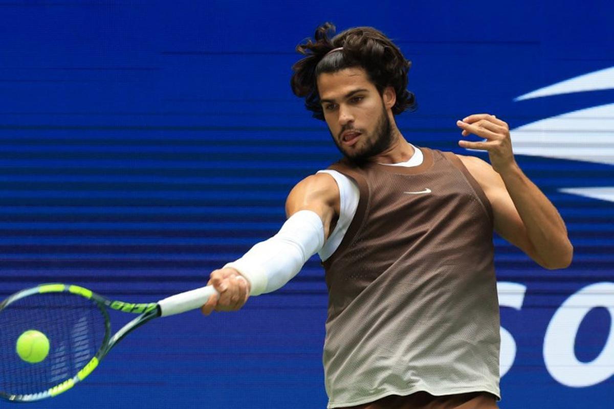 Spain's Carlos Alcaraz hits a return to China's Wu Yibing during their men's singles third round tennis match on day six of the US Open tennis tournament at the USTA Billie Jean King National Tennis Center in New York City on September 4, 2026.  TIMOTHY A. CLARY / AFP