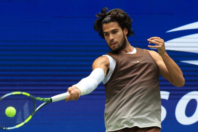 Spain's Carlos Alcaraz hits a return to China's Wu Yibing during their men's singles third round tennis match on day six of the US Open tennis tournament at the USTA Billie Jean King National Tennis Center in New York City on September 4, 2026.  TIMOTHY A. CLARY / AFP