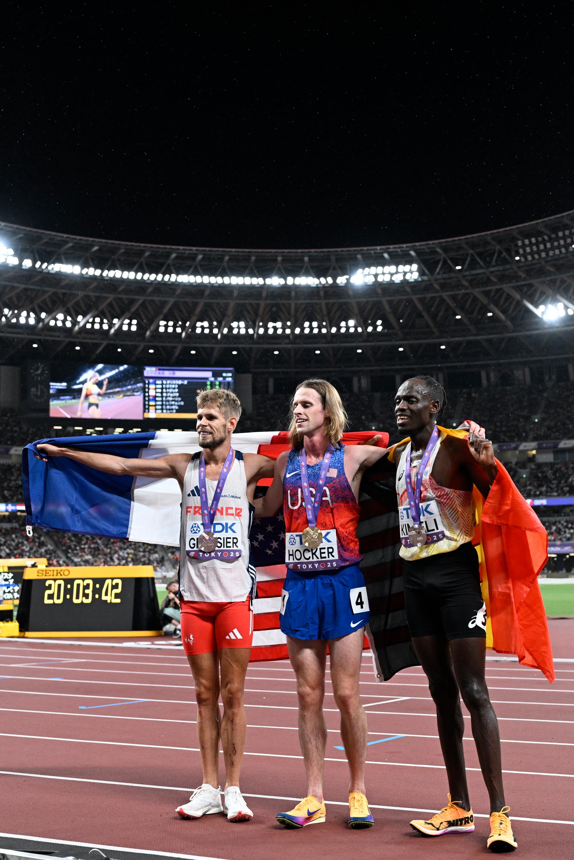 French Jimmy Gressier, US Cole Hocker and Belgian Isaac Kimeli celebrate after the 5000m men final, at the World Athletics Championships in Tokyo, Japan, on Sunday 21 September 2025. The outdoor Worlds are taking place from 13 to 21 September. BELGA PHOTO JASPER JACOBS