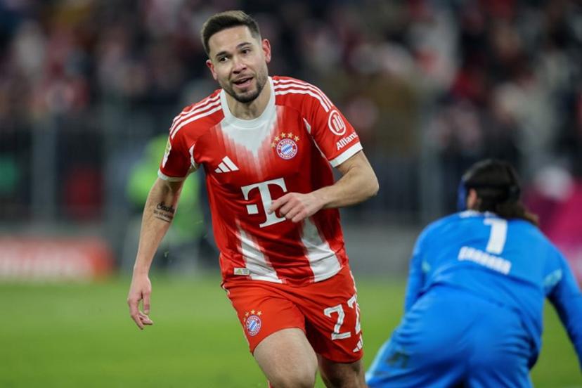 Bayern Munich's Portuguese defender #22 Raphael Guerreiro celebrates scoring the 5-1 goal during the German first division Bundesliga football match between FC Bayern Munich and VfL Wolfsburg in Munich, southern Germany, on January 11, 2026.  Alexandra BEIER / AFP