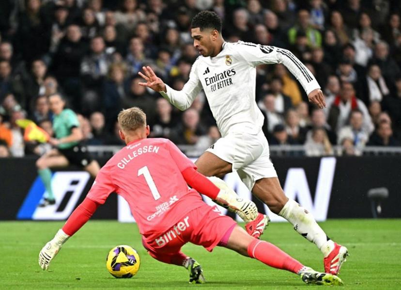 Real Madrid's English midfielder #05 Jude Bellingham challenges Las Palmas' Dutch goalkeeper #01 Jasper Cillessen during Spanish league football match between Real Madrid CF and UD Las Palmas at the Santiago Bernabeu stadium in Madrid on January 19, 2025.  JAVIER SORIANO / AFP