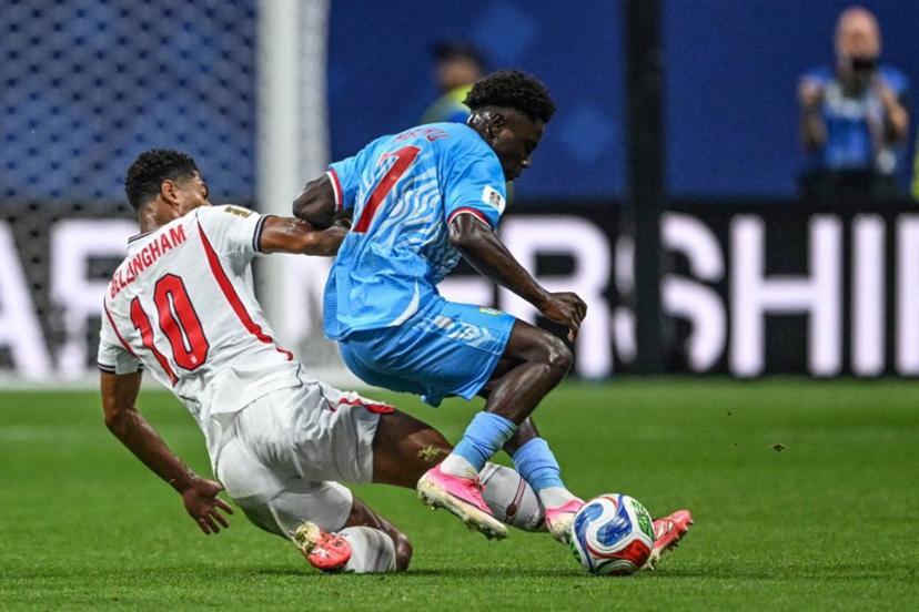 England's midfielder #10 Jude Bellingham and Congo DR's midfielder #07 Nathanael Mbuku fight for the ball during the 2026 World Cup round of 32 match football between England and the Democratic Republic of Congo at the Atlanta Stadium in Atlanta on July 1, 2026.   ROBERTO SCHMIDT / AFP