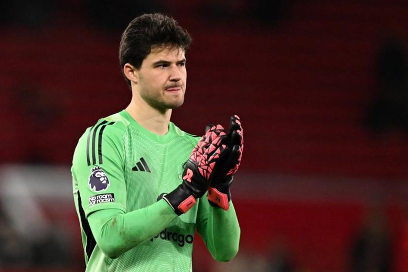 Manchester United's Belgian goalkeeper #31 Senne Lammens applauds the crowd at the end of the English Premier League football match between Manchester United and Bournemouth at Old Trafford in Manchester, north west England, on December 15, 2025.  PETER POWELL / AFP