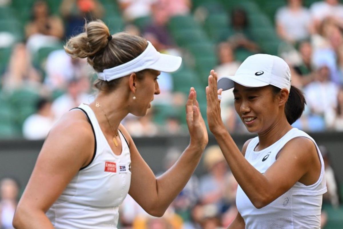 Belgium's Elise Mertens (L) and China's Zhang Shuai play against Czech Republic's Barbora Krejcikova and Czech Republic's Katerina Siniakova during their women's doubles final tennis match on the fourteenth day of the 2022 Wimbledon Championships at The All England Tennis Club in Wimbledon, southwest London, on July 10, 2022.   SEBASTIEN BOZON / AFP