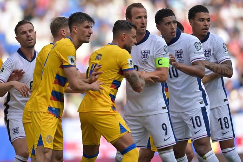 England forward #18 Morgan Rogers, England's midfielder #10 Jude Bellingham and England's forward #09 Harry Kane vie with Andorra's defender #15 Moises San Nicolas (C) and Andorra's midfielder #19 Joel Guillen Garcia (5R) during the 2026 World Cup qualifiers Europe zone, 1st round group K football match between Andorra and England at RCDE Stadium in Cornella de Llobregat, on June 7, 2025.  MANAURE QUINTERO / AFP