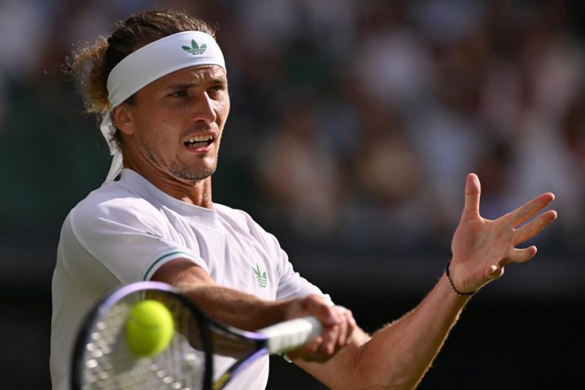 Germany's Alexander Zverev plays a forehand return to France's Arthur Rinderknech during their men's singles first round tennis match on the second day of the 2025 Wimbledon Championships at The All England Lawn Tennis and Croquet Club in Wimbledon, southwest London, on July 1, 2025.  Glyn KIRK / AFP