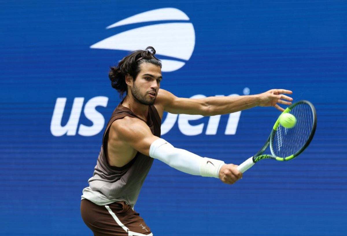 Spain's Carlos Alcaraz hits a return to Russia's Roman Safiullin during their men's singles first round tennis match on day two of the US Open tennis tournament at the USTA Billie Jean King National Tennis Center in New York City on August 31, 2026.  TIMOTHY A. CLARY / AFP