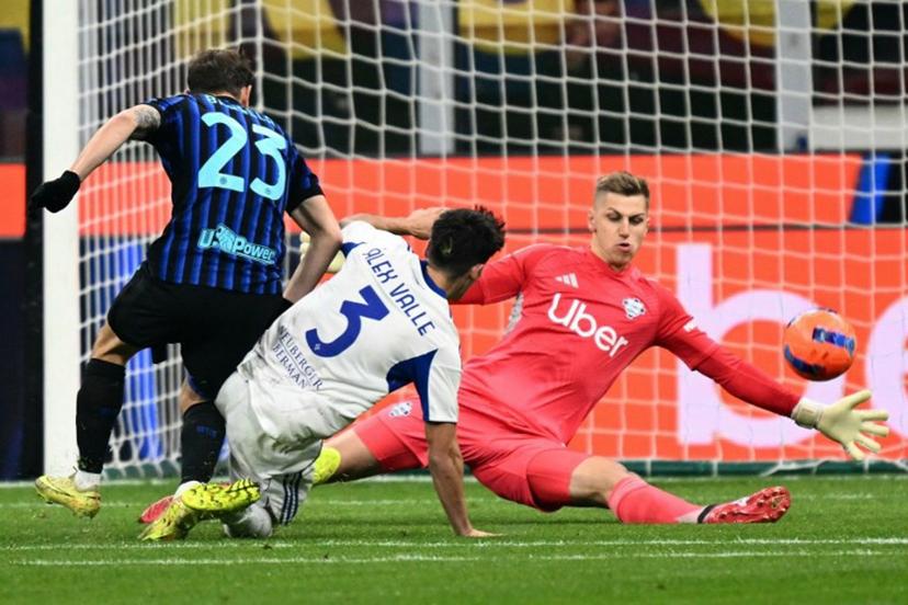 Inter Milan's Italian midfielder #23 Nicolo Barella tries to score against Como's French goalkeeper #01 Jean Butez during the Italian Serie A football match between Inter Milan and Como at San Siro stadium in Milan, on December 6, 2025.  Stefano RELLANDINI / AFP