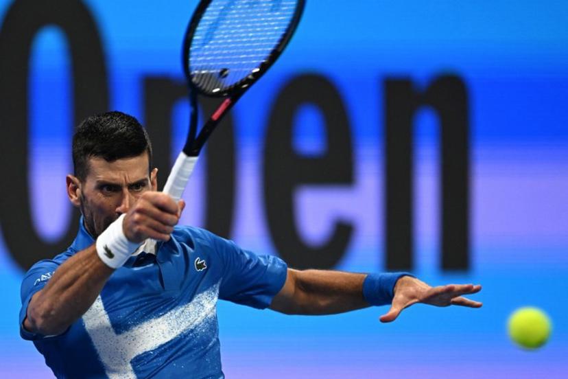 Serbia's Novak Djokovic hits a return to Italy's Matteo Berettini during their men's singles match at the ATP Qatar Open tennis tournament in Doha on February 18, 2025.  Mahmud HAMS / AFP