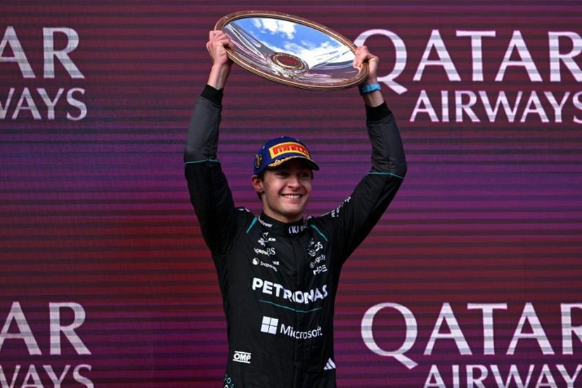 Mercedes' British driver George Russell celebrates on the podium after winning the Formula One Australian Grand Prix at the Albert Park Circuit in Melbourne on March 8, 2026.   WILLIAM WEST / AFP