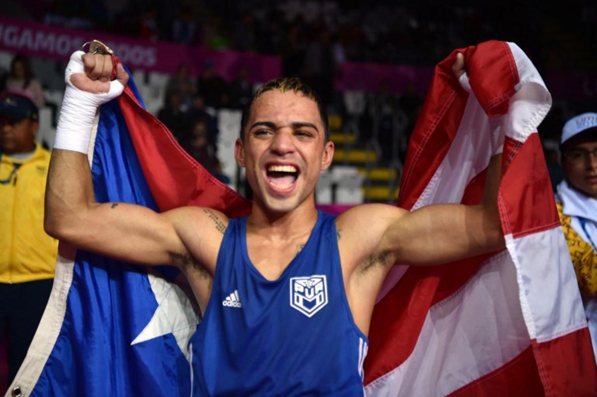 Puerto Rico's Oscar Collazo celebrates after defeating Colombia's Yuberjen Martinez to win the gold medal in the Men's Light Fly (46-49kg) Finals Bout of the Boxing competition Lima 2019 Pan-American Games at the Miguel Grau Coliseum in Callao on August 2, 2019.  Cris BOURONCLE / AFP