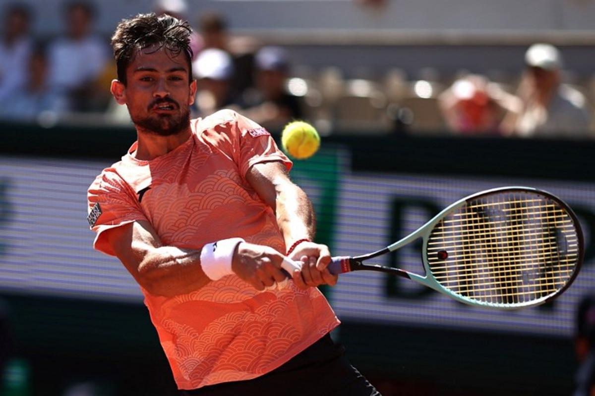 Argentina's Mariano Navone plays a backhand return to Italy's Lorenzo Musetti during their men's singles match on day 6 of the French Open tennis tournament on Court Suzanne-Lenglen at the Roland-Garros Complex in Paris on May 30, 2025.  Anne-Christine POUJOULAT / AFP