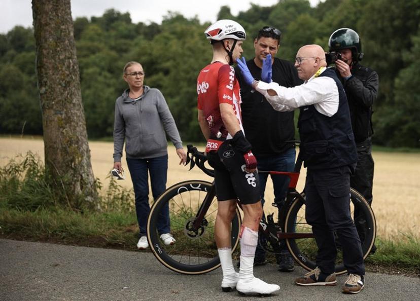 Lotto team's Belgian rider Lennert Van Eetvelt receives medical assistance after suffering a crash during the 2nd stage of the 112th edition of the Tour de France cycling race, 209.1 km between Lauwin-Planque and Boulogne-sur-Mer, Northern France, on July 6, 2025.  Anne-Christine POUJOULAT / AFP