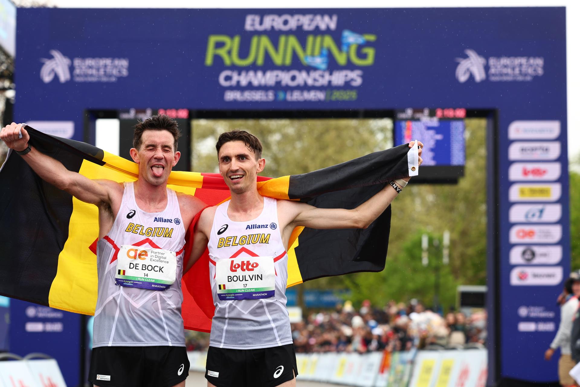 Belgian Thomas De Bock and Belgian Dorian Boulvin pictured at the arrival with a Belgian flag at the men marathon race at European Running Championships, from Leuven to Brussels, Sunday 13 April 2025. BELGA PHOTO DAVID PINTENS