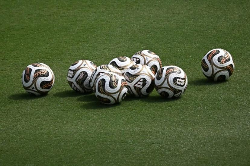 A photo the new official competition footballs for the semi-finals sitting in the pitch at a Spain training session at the at the Cotton Bowl Stadium in Dallas on July 12, 2026, during the 2026 World Cup foorball tournament.   Paul ELLIS / AFP