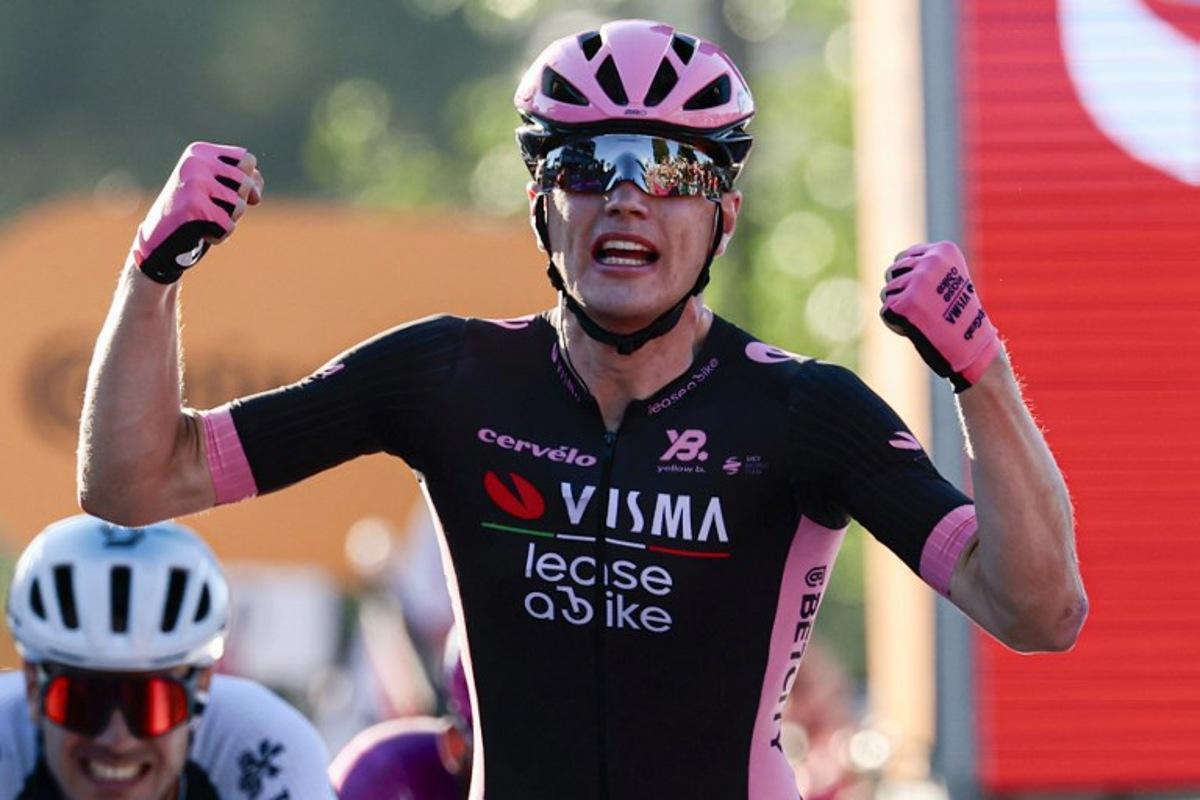 Team Visma-Lease a Bike's Dutch rider Olav Kooij celebrates after victory as he crosses the finish of the 21st and last stage of the 108th Giro d'Italia cycling race of 143kms from Rome to Rome on June 1, 2025.  Luca Bettini / AFP