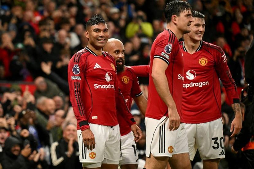Manchester United's Brazilian midfielder #18 Casemiro (R) celebrates scoring the team's second goal during the English Premier League football match between Manchester United and Chelsea at Old Trafford in Manchester, north west England, on September 20, 2025.  Oli SCARFF / AFP