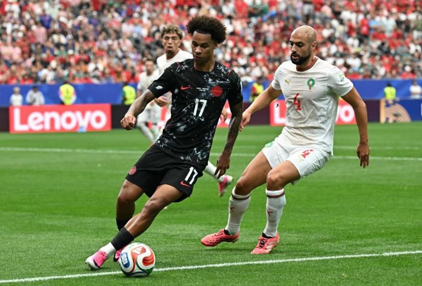 Canada's midfielder #17 Tajon Buchanan controls the ball past Morocco's midfielder #04 Sofyan Amrabat during the 2026 World Cup round of 16 football match between Canada and Morocco at the Houston Stadium in Houston on July 4, 2026.   Paul ELLIS / AFP