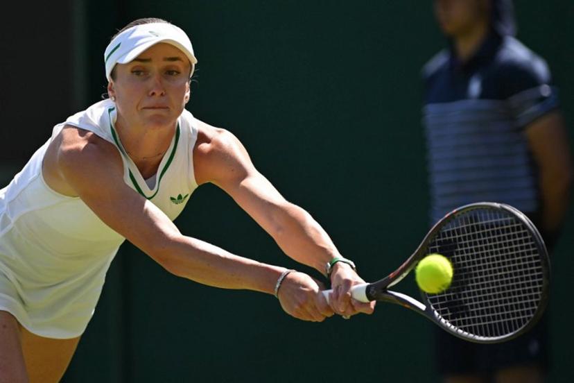 Ukraine's Elina Svitolina plays a backhand return to Hungary's Anna Bondar during their women's singles first round tennis match on the first day of the 2025 Wimbledon Championships at The All England Lawn Tennis and Croquet Club in Wimbledon, southwest London, on June 30, 2025.  Glyn KIRK / AFP