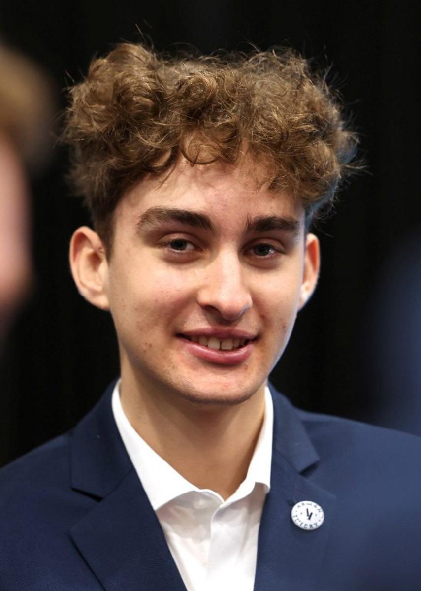 Decathlon-CMA CGM's French rider Paul Seixas looks on during the presentation of the new Decathlon CMA-GGM cycling team at the Decathlon Campus in Villeneuve-d'Ascq, northern France on December 11, 2025.  Francois LO PRESTI / AFP