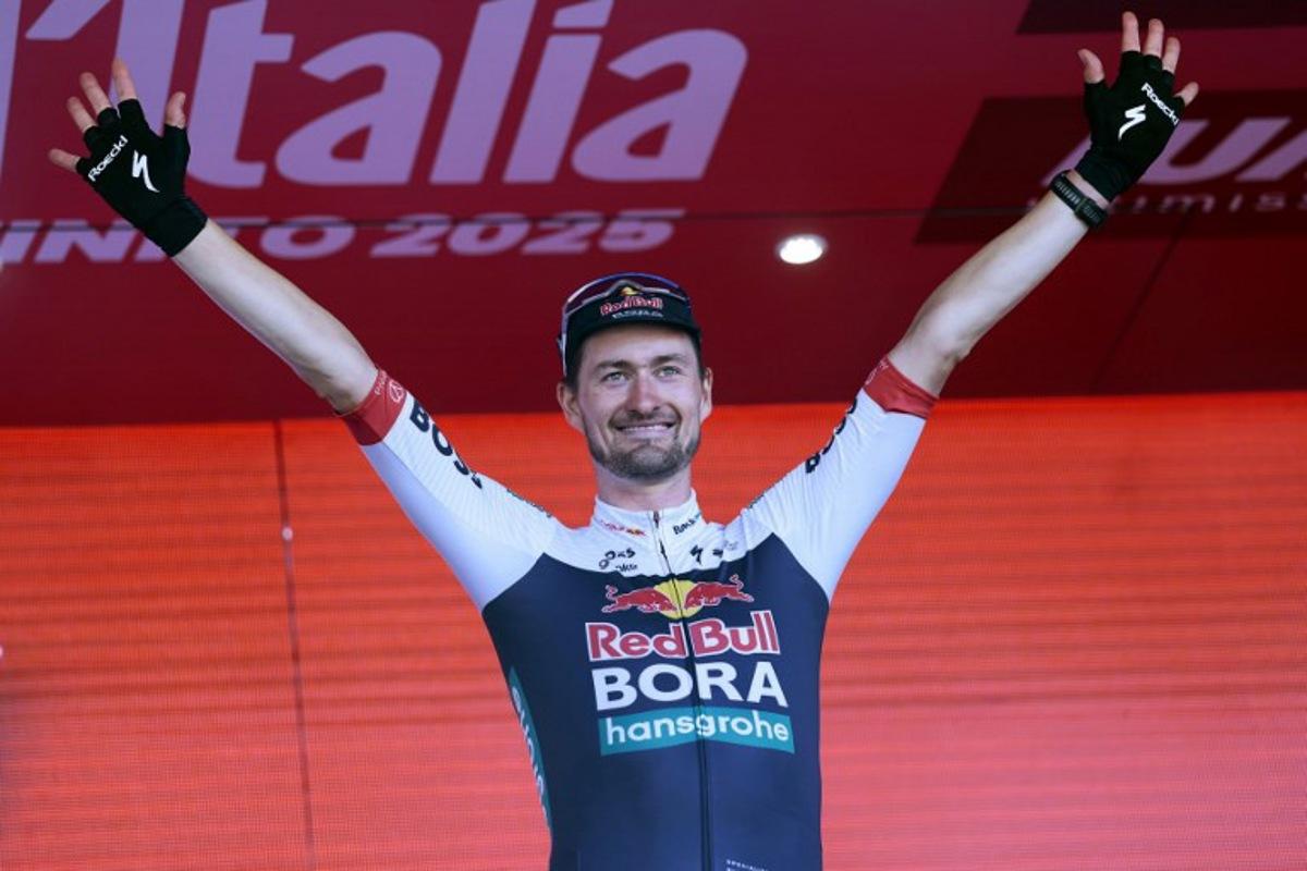 Red Bull-Bora-Hansgrohe's Germany rider Nico Denz celebrates on the podium after winning the 18th stage of the 108th Giro d'Italia cycling race of 144kms from Morbegno to Cesano Maderno on May 29, 2025.  Luca Bettini / AFP