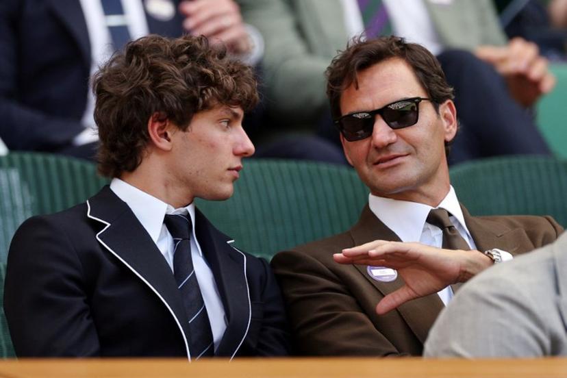 Italian driver Kimi Antonelli (L) listents to Swiss former tennis player Roger Federer at the Centre Court's Royal Box on the eighth day of the 2026 Wimbledon Championships at The All England Lawn Tennis and Croquet Club in Wimbledon, southwest London, on July 6, 2026.  Adrian Dennis / AFP