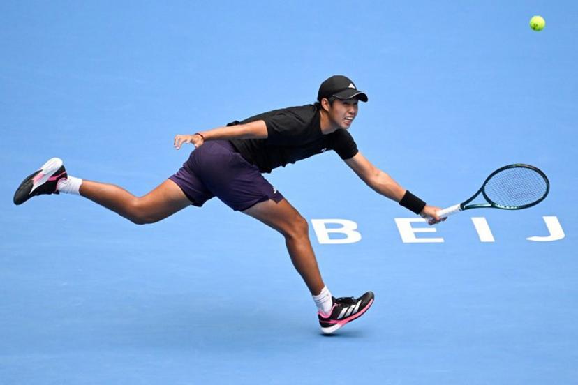 USA's Learner Tien hits a return to Italy's Jannik Sinner during their men's singles final match at the China Open tennis tournament in Beijing on October 1, 2025.   WANG Zhao / AFP