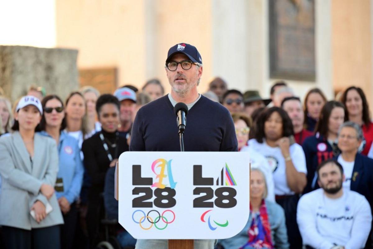 Chairman of the LA2028 Olympics Organizing Committee Casey Wasserman speaks during a ceremonial lighting of the LA28 Olympic cauldron at the Memorial Coliseum in Los Angeles on January 13, 2026, ahead of the launch of ticket registration for the 2028 Summer Olympic Games.  Frederic J. Brown / AFP