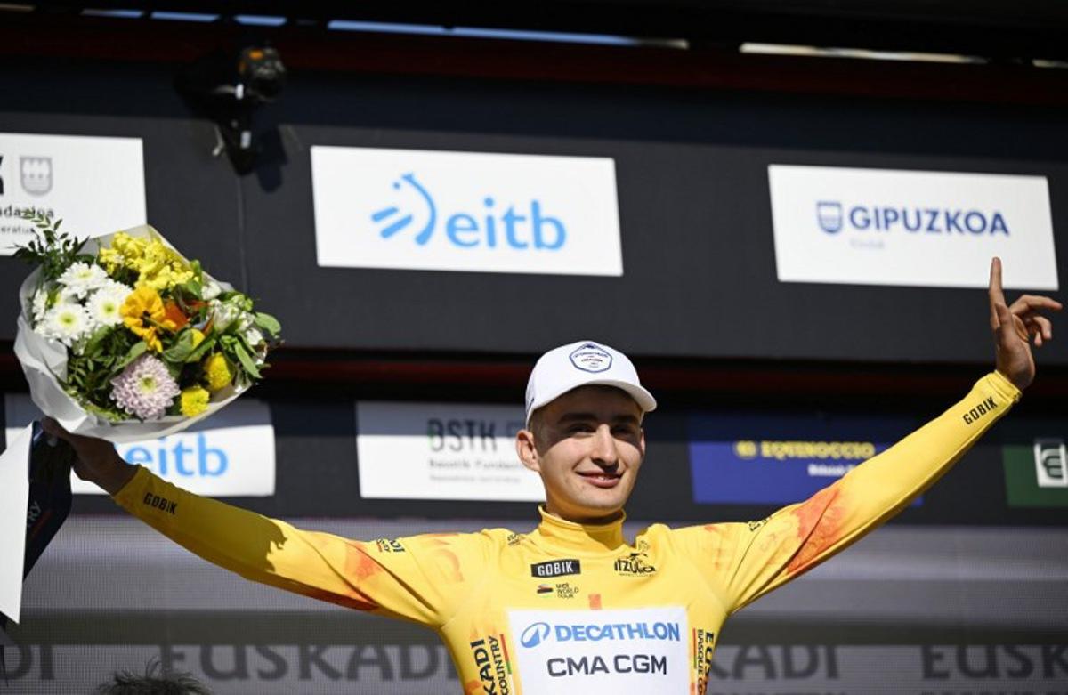 Stage winner Team Decathlon CMA CGM's French rider Paul Seixas stands on the podium wearing the Overall Ranking Leader's yellow jersey after the first stage of the Basque Country's Itzulia cycling tour, a 13.8 km time trial in Bilbao on April 6, 2026.   ANDER GILLENEA / AFP