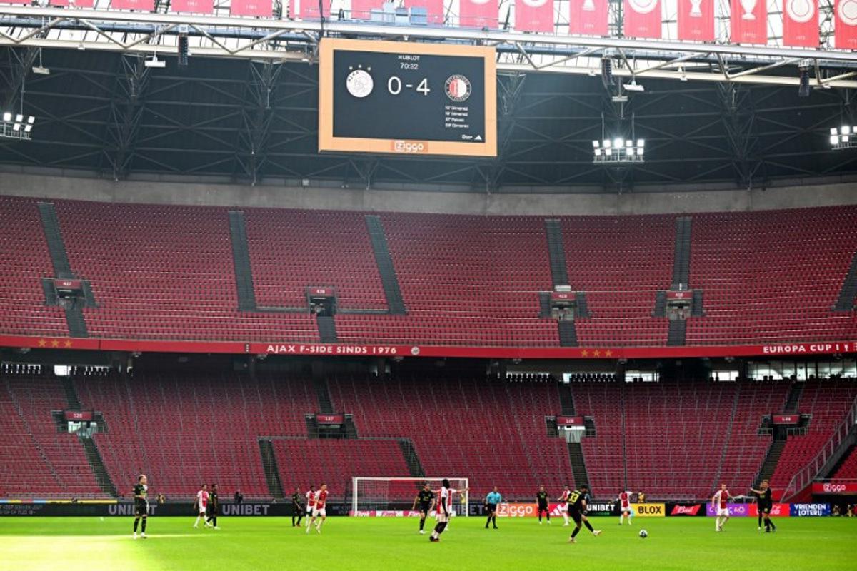 A photo shows empty stands during the Dutch Eredivisie football match between Ajax Amsterdam and Feyenoord Rotterdam at the Johan Cruijff ArenA in Amsterdam on September 27, 2023. The match, played behind closed doors, resumes after being stopped on September 24 after 55 minutes following repeated fireworks on the field, with Feyenoord taking a 3-0 lead. Olaf Kraak / ANP / AFP