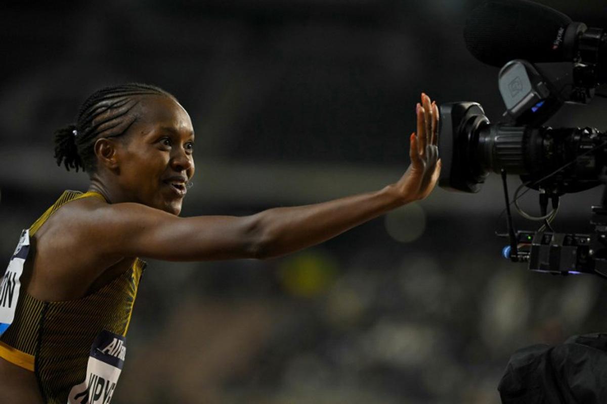 Kenya's Faith Kipyegon celebrates after winning the Women's 1500m final of the Memorial Van Damme Diamond League athletics finals at the Roi Baudouin Stadium in Brussels on September 14, 2024.  NICOLAS TUCAT / AFP
