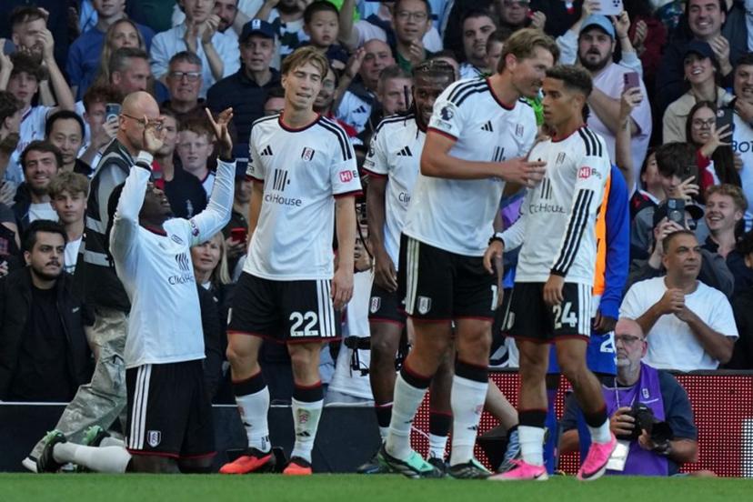 Fulham's players celebrate their first goal, an own-goal scored by Manchester United's Argentinian defender #06 Lisandro Martinez during the English Premier League football match between Fulham and Manchester United at Craven Cottage in London on September 20, 2026.  CARLOS JASSO / AFP