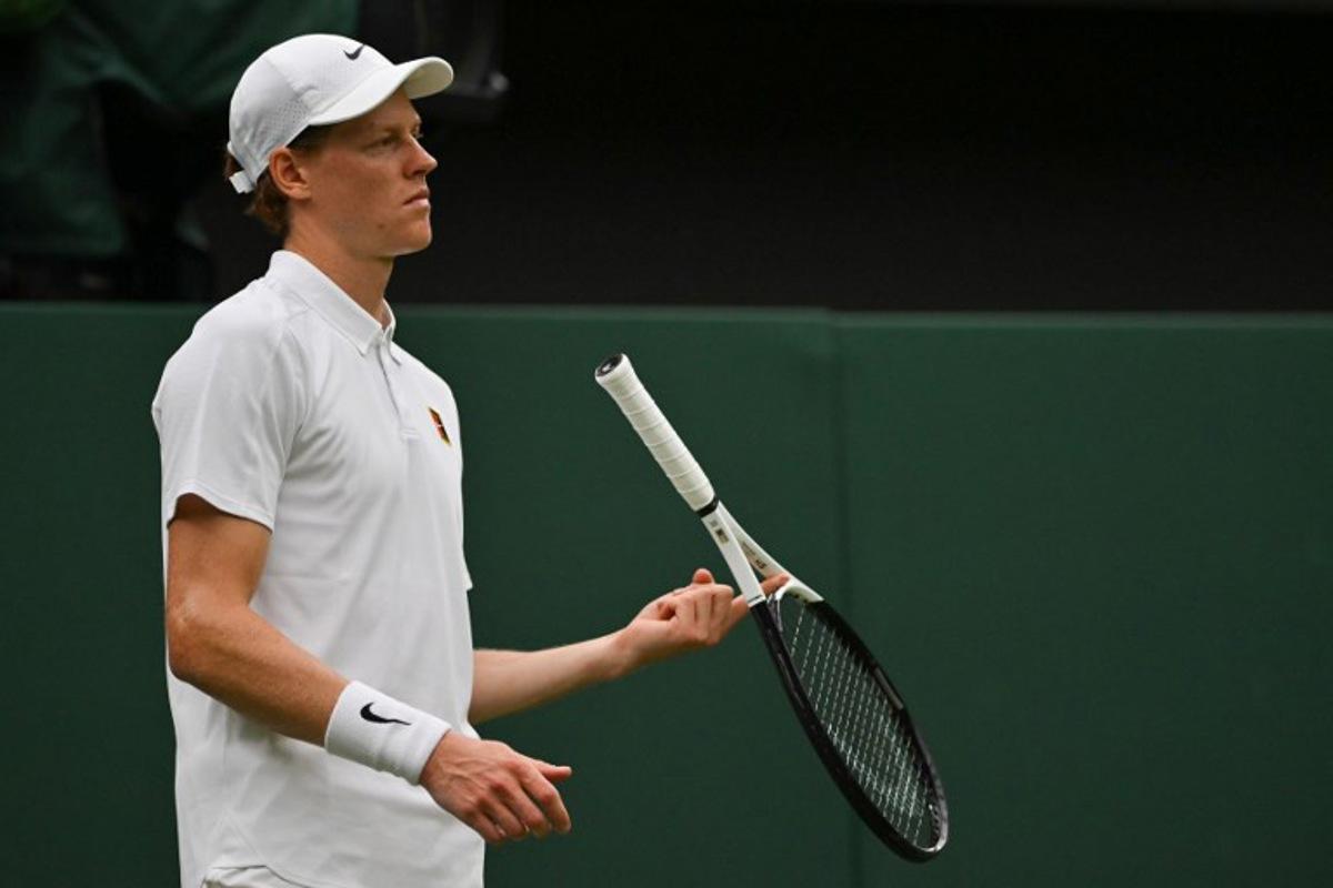 Italy's Jannik Sinner plays with his racket during his men's singles third round tennis match against Spain's Pedro Martinez on the sixth day of the 2025 Wimbledon Championships at The All England Lawn Tennis and Croquet Club in Wimbledon, southwest London, on July 5, 2025.  Glyn KIRK / AFP